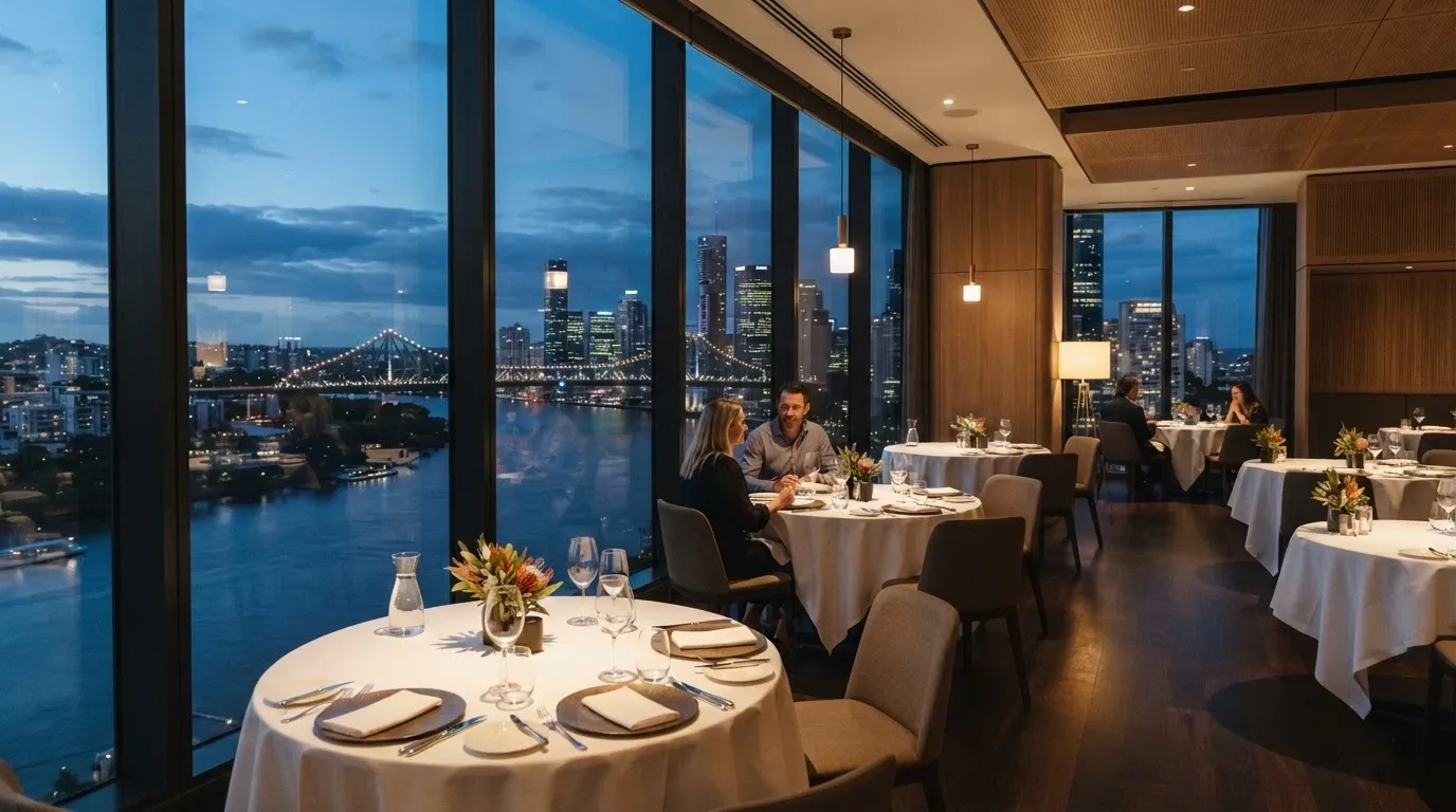 Aloria's dining room on level 23 with floor-to-ceiling windows overlooking the Brisbane River and city