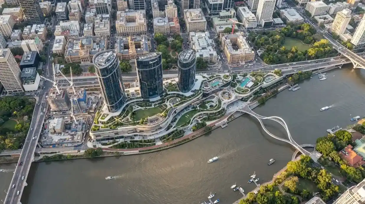 Aerial view of the Queen's Wharf Brisbane precinct showing the riverfront footprint, heritage buildings and the Neville Bonner Bridge