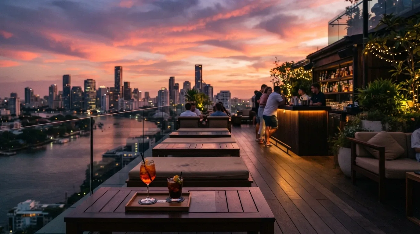 The Sol Rooftop bar at SkyCity Adelaide at sunset, with city views, cocktail glasses and lounge seating